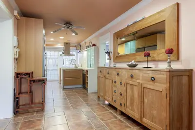 a kitchen with a large wooden cabinet and a sink at Villa Drago in Castelldefels