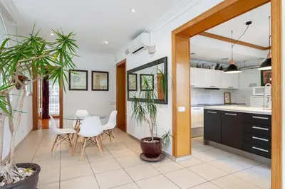 a kitchen and dining room with a table and chairs at Villa Drago in Castelldefels