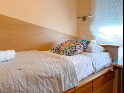 a bed with a pillow on it in a bedroom at Apartment Rivel in Cubelles