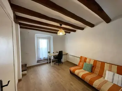 a living room with a couch and a table at Ca la Neus - Casa per 8 persones al poble de Mura in Mura