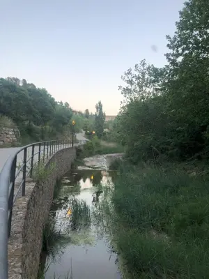 a bridge over a river next to a road at Ca la Neus - Casa per 8 persones al poble de Mura in Mura