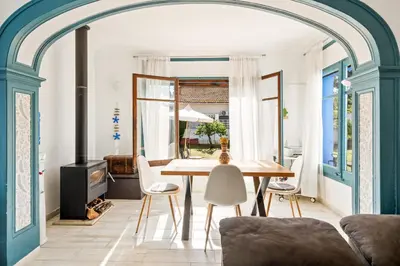 a dining room with a table and chairs at Atenea Room by the Beach - Claire Homes in Castelldefels