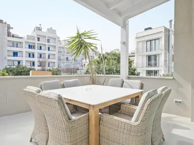 a dining room with a table and chairs on a balcony at Sitges Spaces Urban Beach Flat- 3 Bedrooms, 3 Bathrooms, Huge Terrace, Near Beach in Sitges