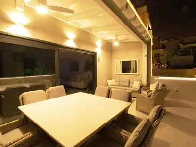 a dining room with a white table and chairs at Sitges Spaces Urban Beach Flat- 3 Bedrooms, 3 Bathrooms, Huge Terrace, Near Beach in Sitges