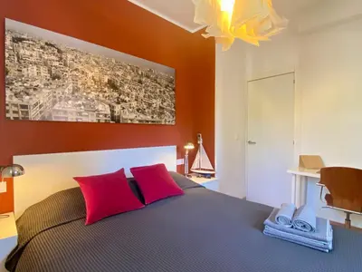 a bedroom with a bed with red pillows at Pineda 38 in Gavà