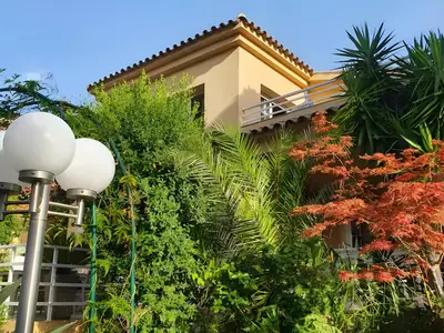 a building with a street light and plants at Cabril's Hills Luxe Suites in Cabrils