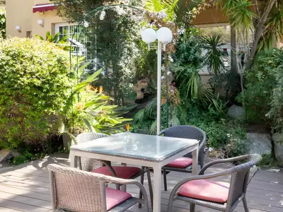 a table and chairs on a patio at Cabril's Hills Luxe Suites in Cabrils