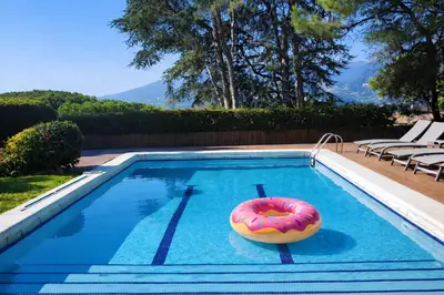 a bottle of wine and a glass next to a swimming pool at Cabril's Hills Luxe Suites in Cabrils