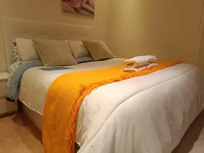 a bedroom with a large bed with a red headboard at Habitación y baño privado in Vilanova del Camí