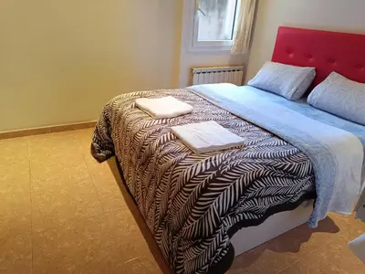 a bedroom with a bed with two towels on it at Habitación y baño privado in Vilanova del Camí