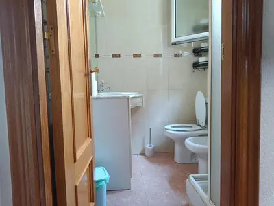 a small bathroom with a toilet and a sink at Habitación y baño privado in Vilanova del Camí