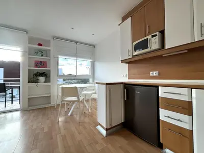 a kitchen with a counter and a table with chairs at Panoramic view Gavà Mar in Gavà