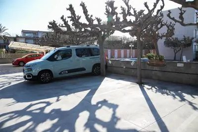 a small white car parked next to a tree at Panoramic view Gavà Mar in Gavà