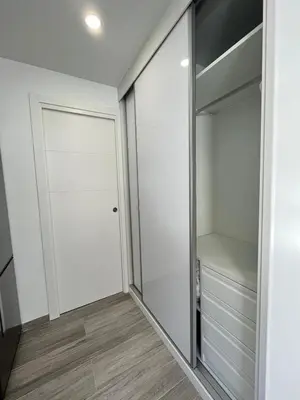 a walk in closet with a glass door at Beautiful renovated studio in Castelldefels