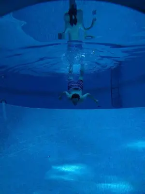 a person swimming in a pool in the water at VILLA Mar y Montaña in Castelldefels