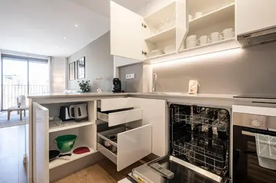 a kitchen with white cabinets and an oven at CATERINA Bac de Roda in Barcelona