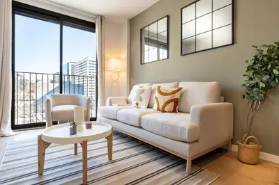 a living room with a white couch and a table at CATERINA Bac de Roda in Barcelona