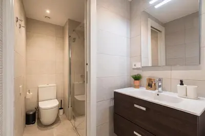 a bathroom with a sink and a toilet and a shower at CATERINA Bac de Roda in Barcelona