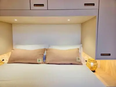 a white bed with two pillows in a bedroom at Stunning APT WiFi 6 min Sagrada Familia 2BR in Barcelona