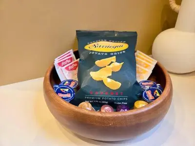 a wooden bowl filled with candy on a table at Stunning APT WiFi 6 min Sagrada Familia 2BR in Barcelona