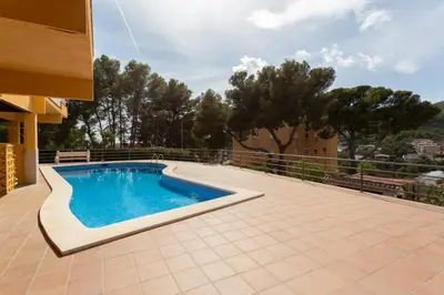 a swimming pool on a patio next to a building at Apartamento en castelldefels in Castelldefels