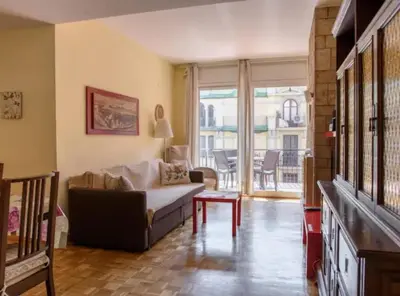 a living room with a couch and a table at Ramblas Rentals Unique & Spacious Flat 4BR Terrace 20M Ramblas in Barcelona