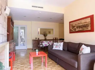 a living room with a couch and a table at Ramblas Rentals Unique & Spacious Flat 4BR Terrace 20M Ramblas in Barcelona