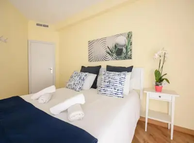 a bedroom with a large white bed with pillows at Ramblas Rentals Unique & Spacious Flat 4BR Terrace 20M Ramblas in Barcelona