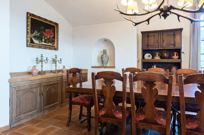 a dining room with a wooden table and chairs at El Mirador Esencia Mediterránea in Arenys de Mar