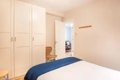 a white bedroom with a bed and a closet at Spacious and elegant oasis in the best location, Eixample Barcelona in Barcelona