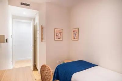 a bedroom with a bed and a table with a blue blanket at Spacious and elegant oasis in the best location, Eixample Barcelona in Barcelona