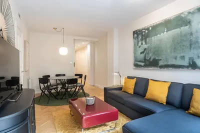 a living room with a blue couch and a table at Spacious and elegant oasis in the best location, Eixample Barcelona in Barcelona