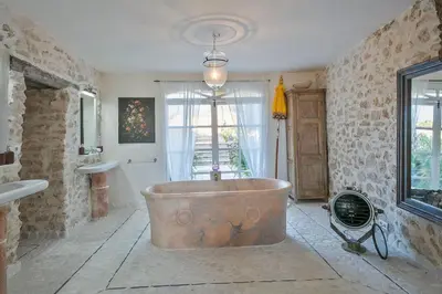 a large copper tub in a bathroom with a window at Alcazar Del Garraf in Olivella