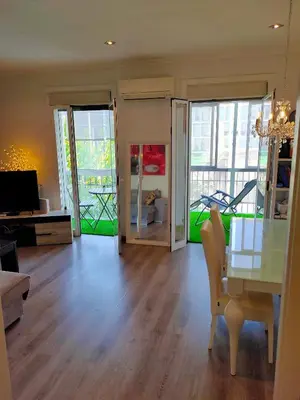 a living room with a table and a dining room at Vilamari 33 - 2 bedroom apartment in Barcelona