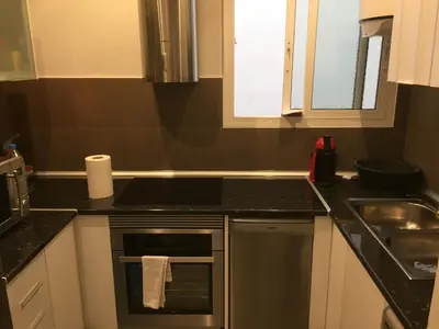 a kitchen with a stove top oven next to a sink at Vilamari 33 - 2 bedroom apartment in Barcelona