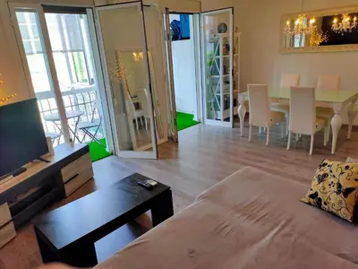 a living room with a couch and a table and a dining room at Vilamari 33 - 2 bedroom apartment in Barcelona
