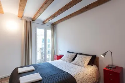 a bedroom with a bed and a large window at Central Azulete in Barcelona
