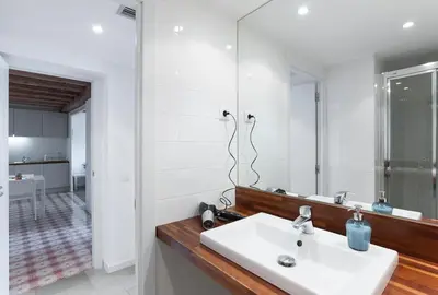 a bathroom with a white sink and a mirror at Central Azulete in Barcelona
