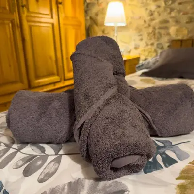 a stuffed animal is laying on a bed at Ca l'Esclatat in Santa María de Palautordera