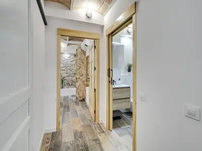 a hallway with a bathroom with a sink and a mirror at Concordia - Beautiful flat, spacious, central 4 rooms , 2 bath in Barcelona
