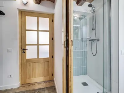 a bathroom with a shower and a glass door at Concordia - Beautiful flat, spacious, central 4 rooms , 2 bath in Barcelona