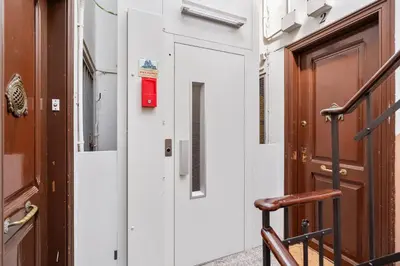 a door with a red box on the side of a building at Gràcia Monthly 1BR Sunny Private Terrace in Barcelona