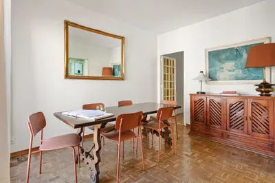 a dining room with a table and chairs and a mirror at 180m² 5BR Home Lift Terrace 32 Nights in Barcelona