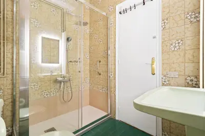 a bathroom with a shower and a toilet and a sink at 180m² 5BR Home Lift Terrace 32 Nights in Barcelona