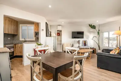 a kitchen and living room with a table and chairs at 55m² Monthly Base w Terrace AC in Barcelona
