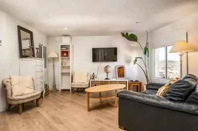 a living room with a couch and a table at 55m² Monthly Base w Terrace AC in Barcelona