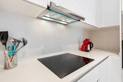 a kitchen counter with a sink and a hood at Diagonal Mar Monthly 2BR Pools Parking in Barcelona