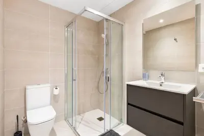a bathroom with a shower and a toilet and a sink at Diagonal Mar Monthly 2BR Pools Parking in Barcelona