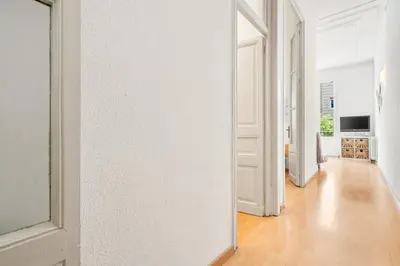 a kitchen with red and white cabinets and a stove at 5BR for 7 Elevator Walk to Sant Antoni in Barcelona