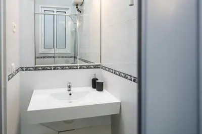 a bathroom with a toilet and a sink and a shower at 5BR for 7 Elevator Walk to Sant Antoni in Barcelona